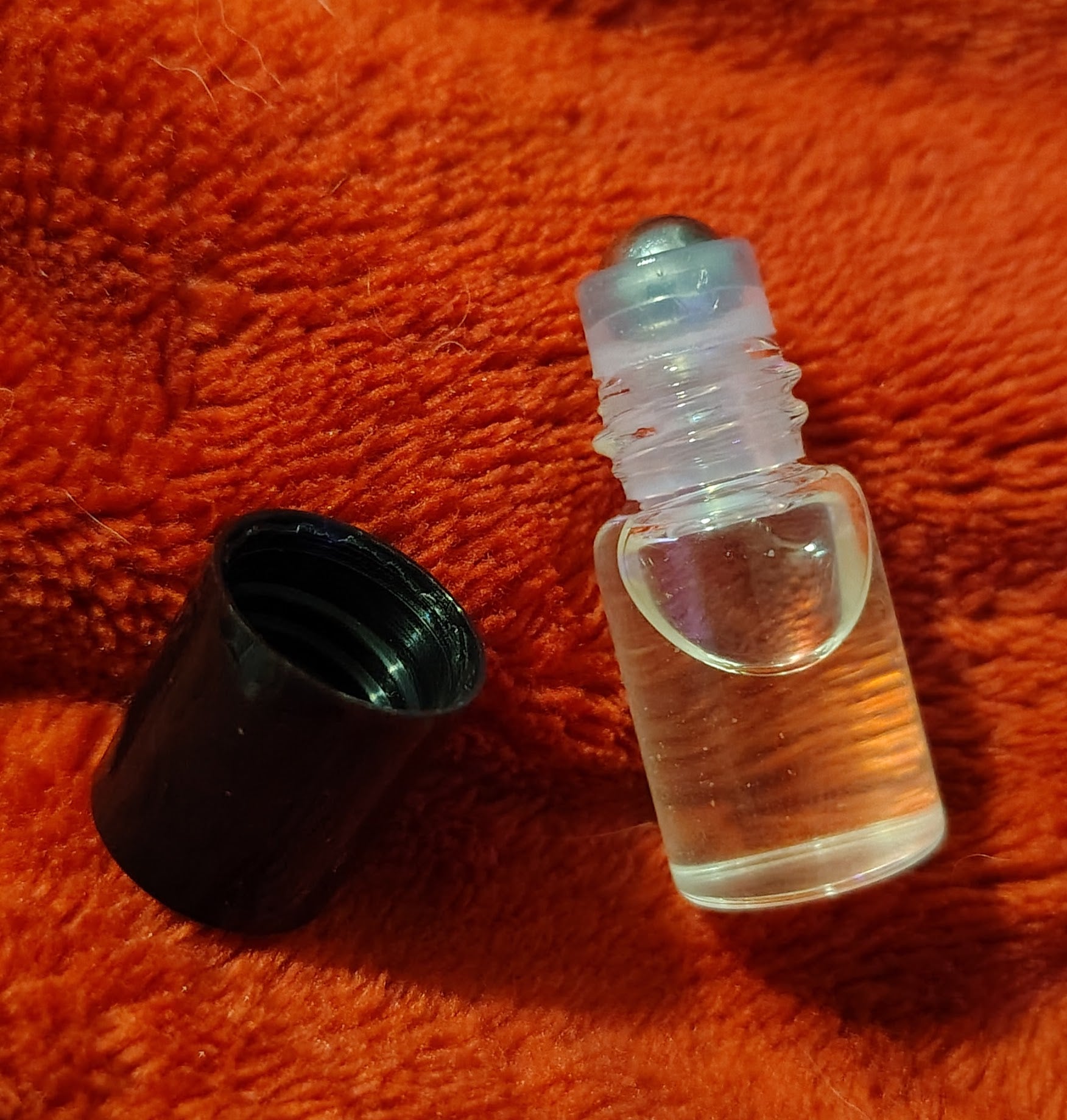 2 ml trial parfum roller bottle with black travel pouch, handmade in Sioux Falls, SD.
