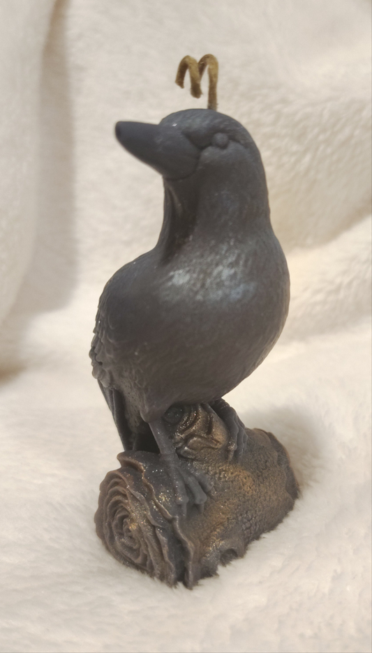 Bronze crow candle on a white background