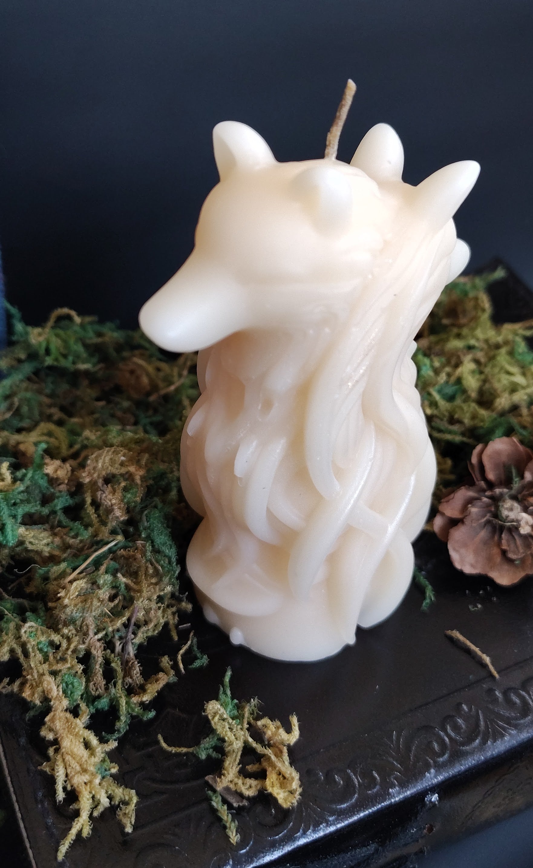 Sculptural candle featuring two intertwined wolves symbolizing duality, handmade in Sioux Falls, SD.