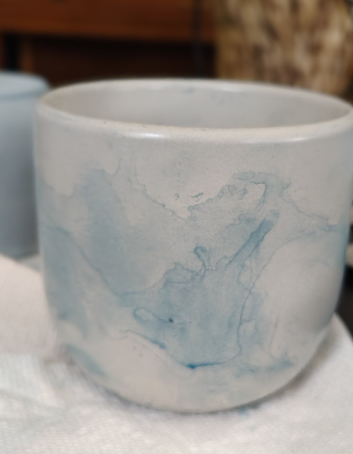 Veil & Flame handmade concrete vessel with blue swirl design. 