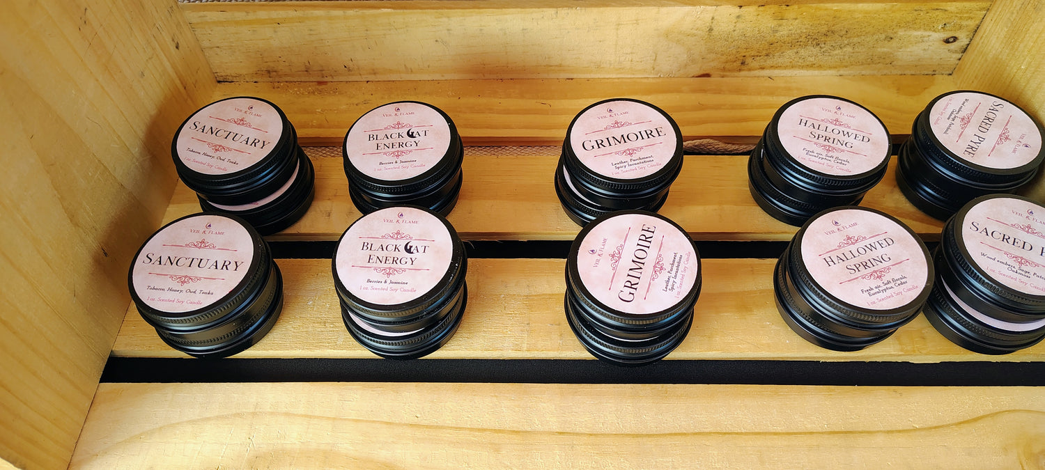 Veil & Flame small discovery candles in black tins with tan gothic themed labels. 