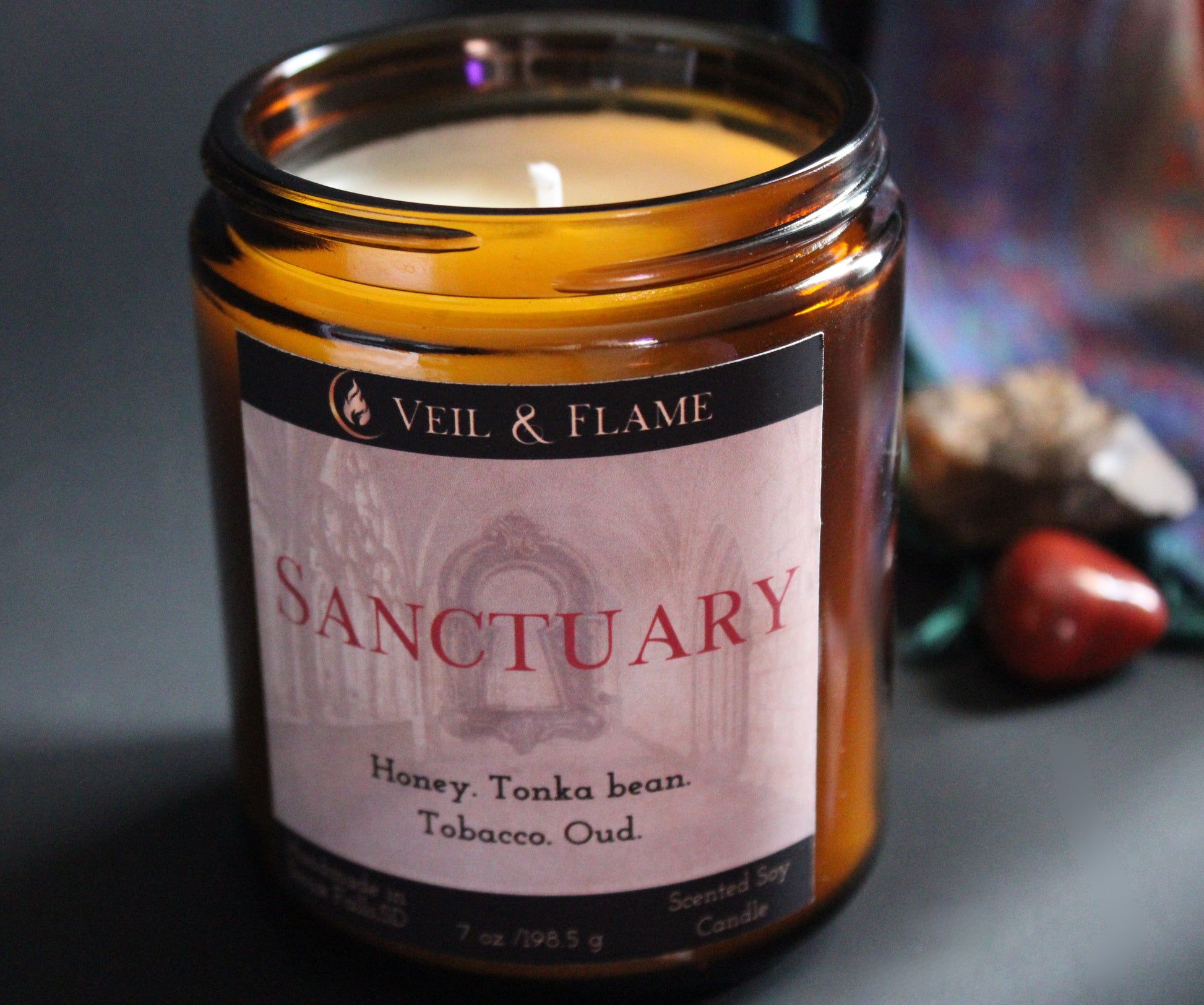 Sanctuary candle in a 7 oz glass vessel, handmade in Sioux Falls, SD with tobacco, oud, honey, and tonka bean scent notes.