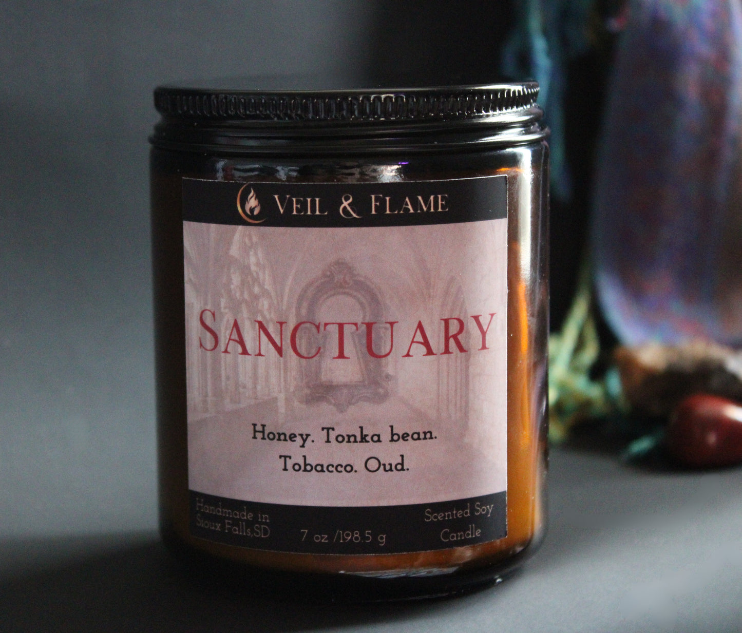 Sanctuary candle in a 7 oz glass vessel, handmade in Sioux Falls, SD with tobacco, oud, honey, and tonka bean scent notes.