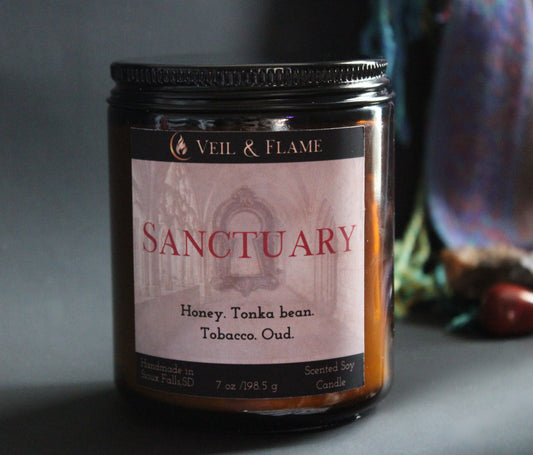 Sanctuary candle in a 7 oz glass vessel, handmade in Sioux Falls, SD with tobacco, oud, honey, and tonka bean scent notes.