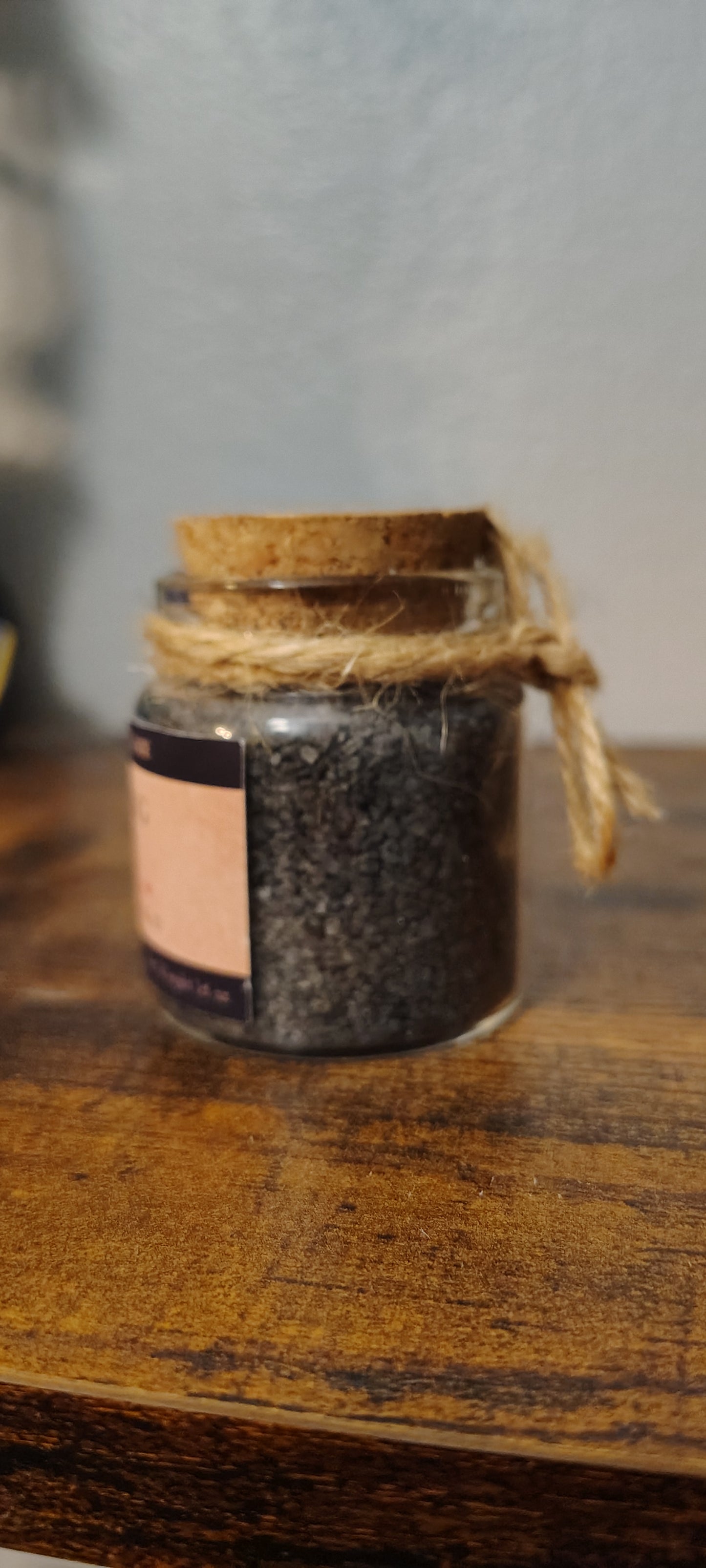 Warding salt in a glass jar with charcoal and herbs, handmade in Sioux Falls, SD.