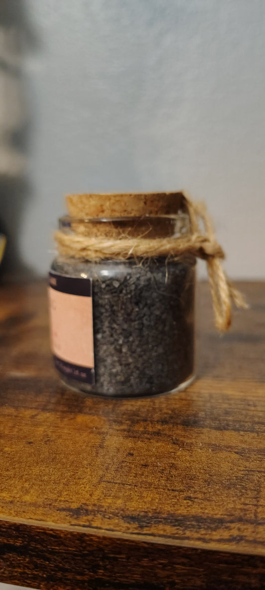 Warding salt in a glass jar with charcoal and herbs, handmade in Sioux Falls, SD.