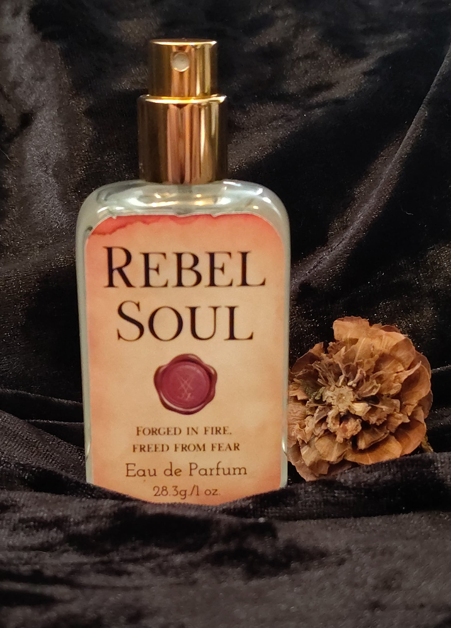 Rebel Soul parfum in a sleek glass bottle, handcrafted in Sioux Falls, SD with citrus‑aromatic scent notes.