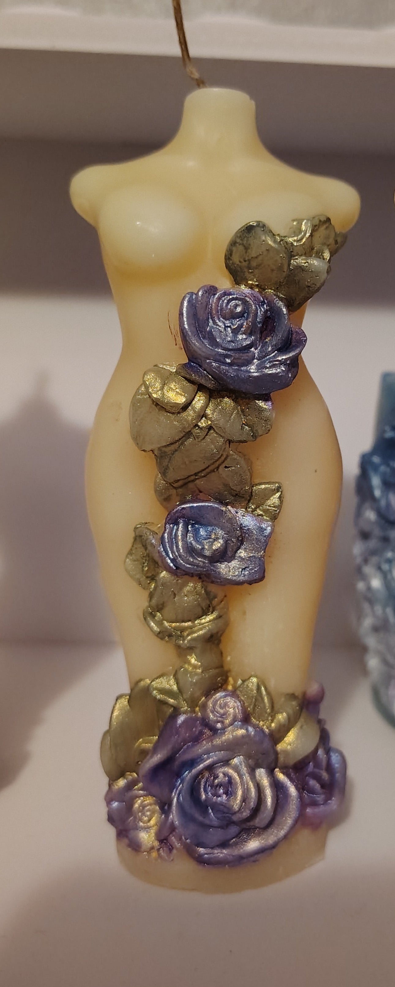 Handcrafted feminine figure candle with blue, purple, and gold floral detailing, made in Sioux Falls, SD.