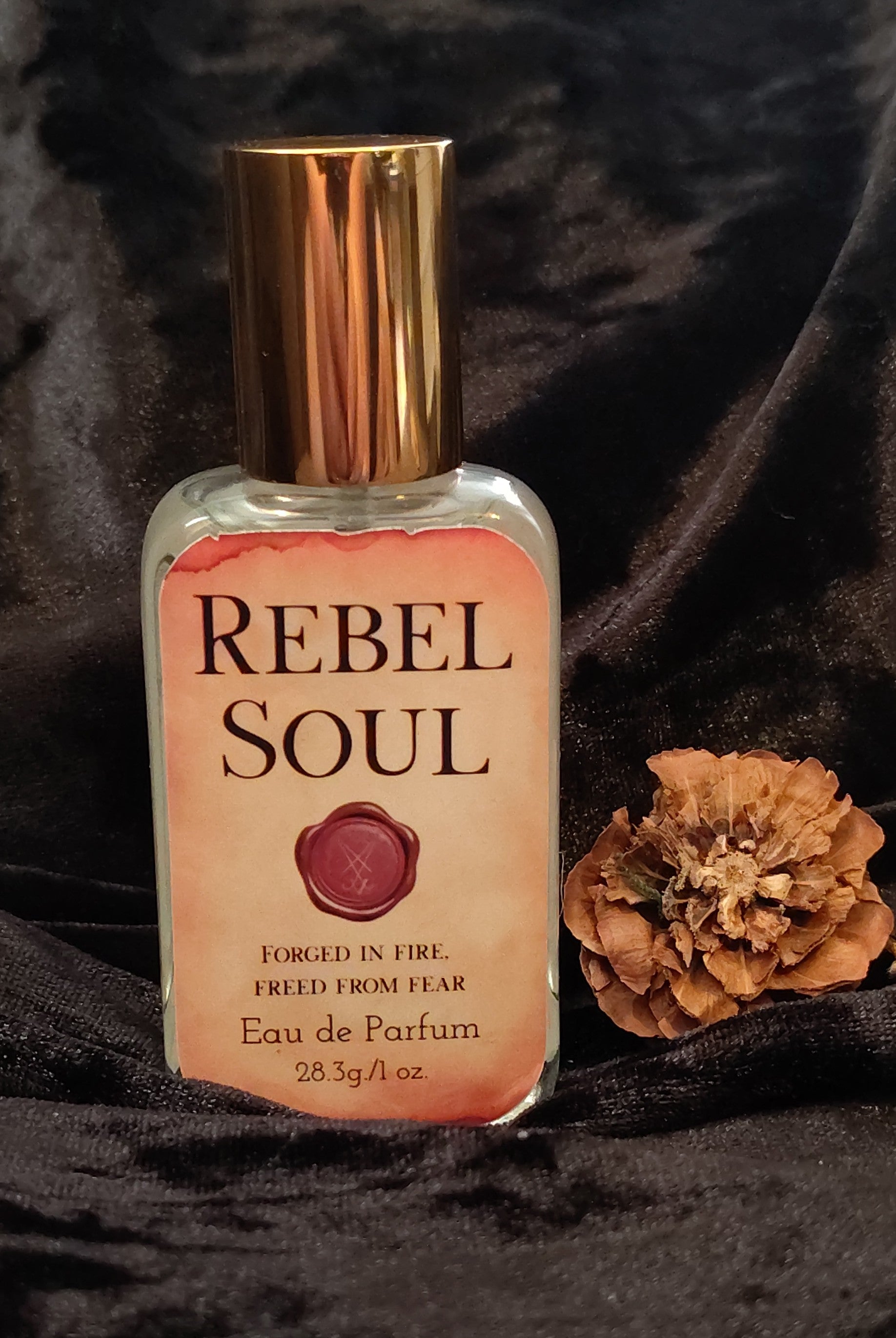 Rebel Soul parfum in a sleek glass bottle, handcrafted in Sioux Falls, SD with citrus‑aromatic scent notes.
