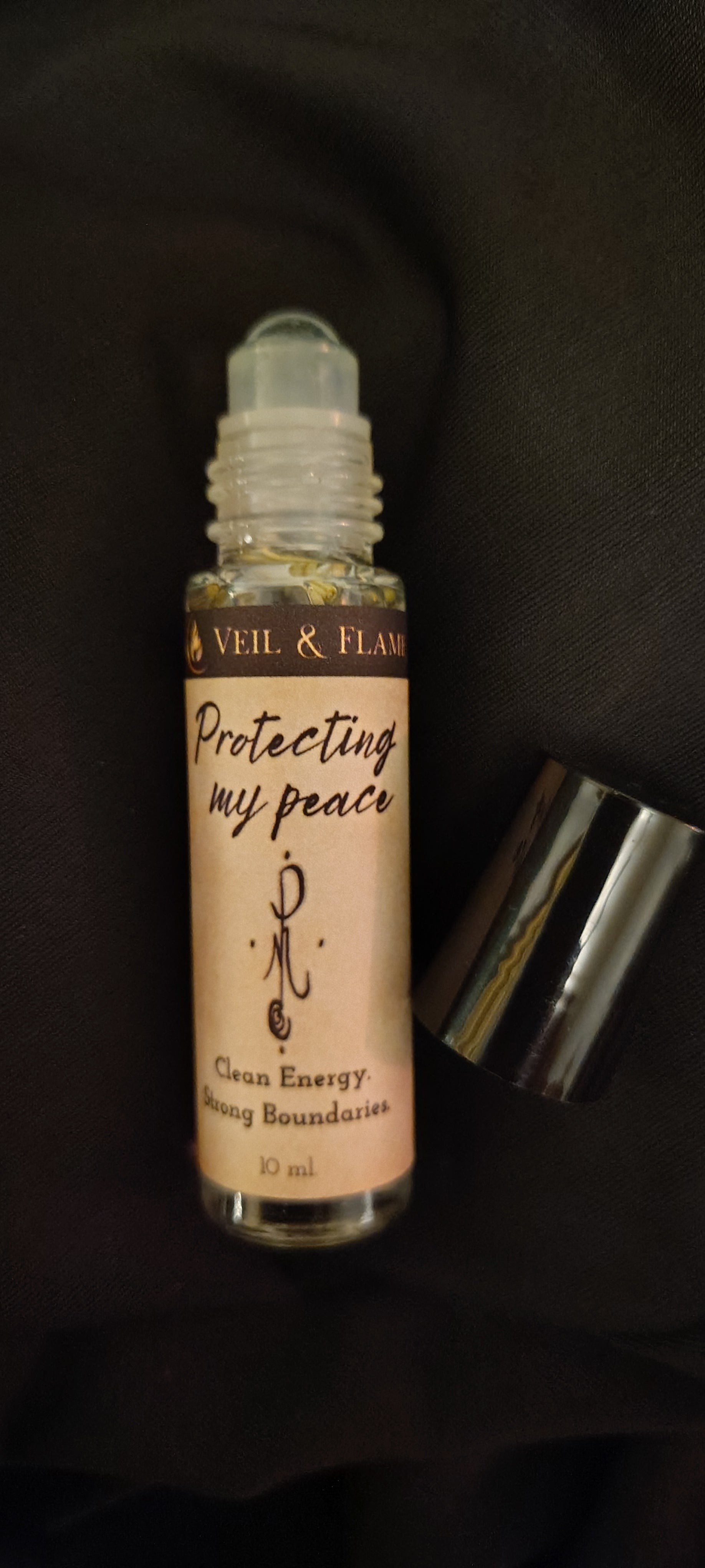 Small rollerball bottle of perfume with a label on a dark background