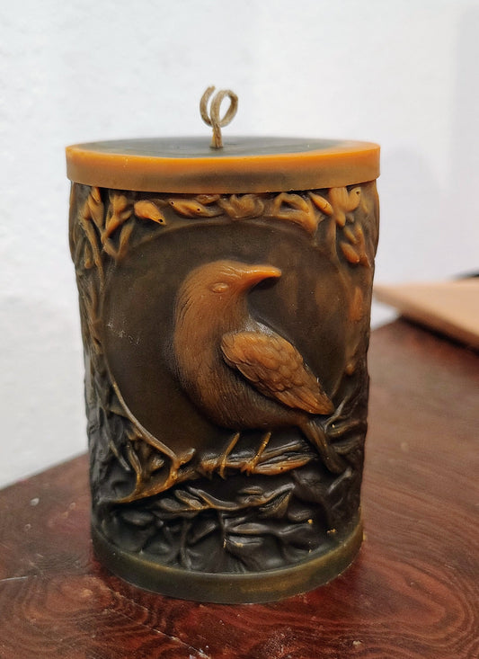 Black crow pillar candle with carved double‑sided crow design and customizable accent color, handmade in Sioux Falls, SD.