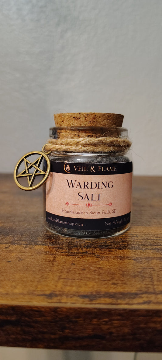 Warding salt in a glass jar with charcoal and herbs, handmade in Sioux Falls, SD.