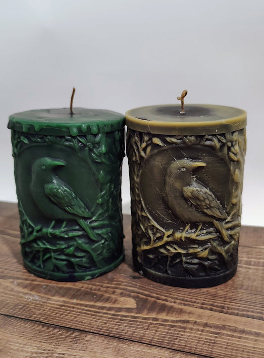 Black crow pillar candle with carved double‑sided crow design and customizable accent color, handmade in Sioux Falls, SD.